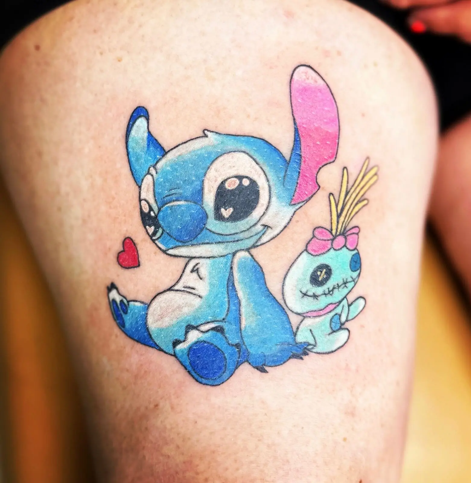Color cartoon Stitch and Scrump from Lilo and Stitch thigh tattoo with heart